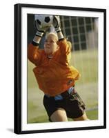 Female Soccer Goalie Catching the Ball-null-Framed Premium Photographic Print