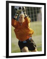 Female Soccer Goalie Catching the Ball-null-Framed Photographic Print