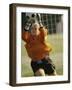 Female Soccer Goalie Catching the Ball-null-Framed Photographic Print