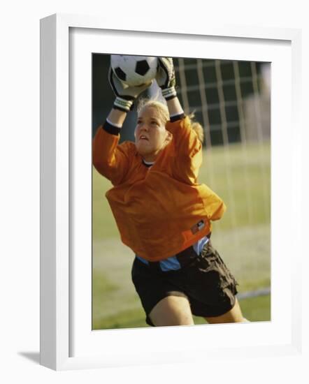 Female Soccer Goalie Catching the Ball-null-Framed Photographic Print