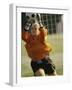 Female Soccer Goalie Catching the Ball-null-Framed Photographic Print