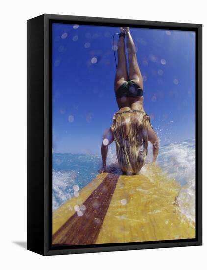 Female Surfer Doing a Headstand on a Surfboard-null-Framed Stretched Canvas