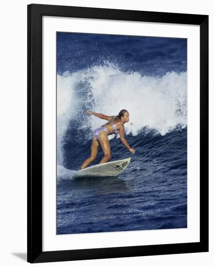 Female Surfer Riding a Wave-null-Framed Photographic Print