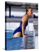 Female Swimmer Climbing Out of the Pool-null-Stretched Canvas