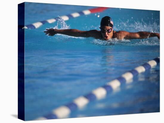 Female Swimmer Competing in a Butterfly Race-null-Stretched Canvas