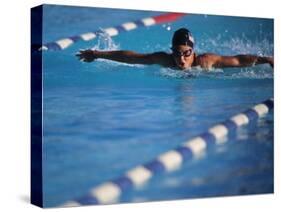 Female Swimmer Competing in a Butterfly Race-null-Stretched Canvas