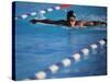 Female Swimmer Competing in a Butterfly Race-null-Stretched Canvas