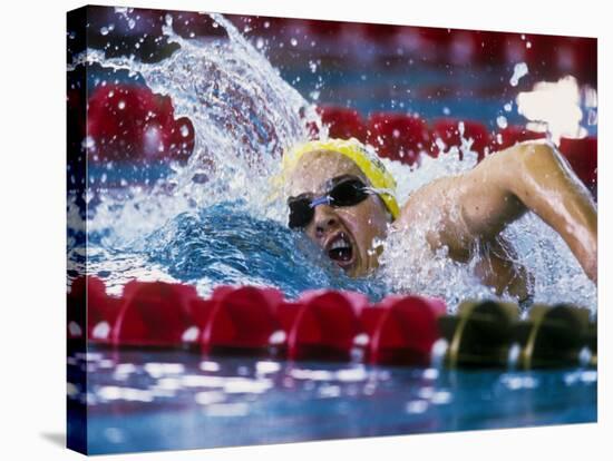 Female Swimmer Competing in a Race-null-Stretched Canvas