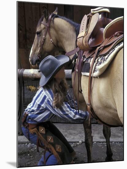 Female Wrangler Saddles Horse at Boulder River Ranch, Montana, USA-Jamie & Judy Wild-Mounted Photographic Print