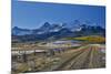 Fence Lined road and San Juan Mountain Range, Colorado-Darrell Gulin-Mounted Photographic Print