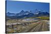 Fence Lined road and San Juan Mountain Range, Colorado-Darrell Gulin-Stretched Canvas