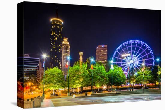 Ferris Wheel and Buildings Seen from Olympic Centennial Park at Night in Atlanta, Georgia.-Jon Bilous-Stretched Canvas