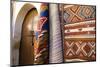 Fez Morocco decorative door and hanging patterned carpets in the old medina-Ellen Clark-Mounted Photographic Print