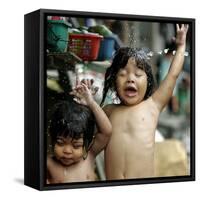 Filipino Children React as They Get a Shower Outside Their Homes-null-Framed Stretched Canvas
