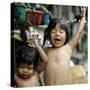 Filipino Children React as They Get a Shower Outside Their Homes-null-Stretched Canvas