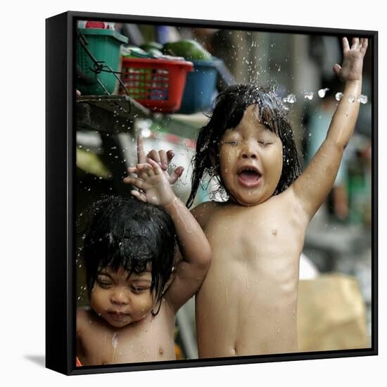 Filipino Children React as They Get a Shower Outside Their Homes-null-Framed Stretched Canvas