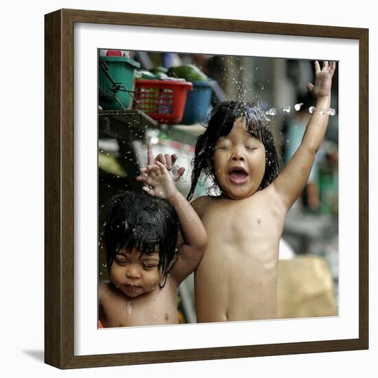 Filipino Children React as They Get a Shower Outside Their Homes-null-Framed Photographic Print