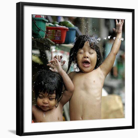 Filipino Children React as They Get a Shower Outside Their Homes-null-Framed Photographic Print