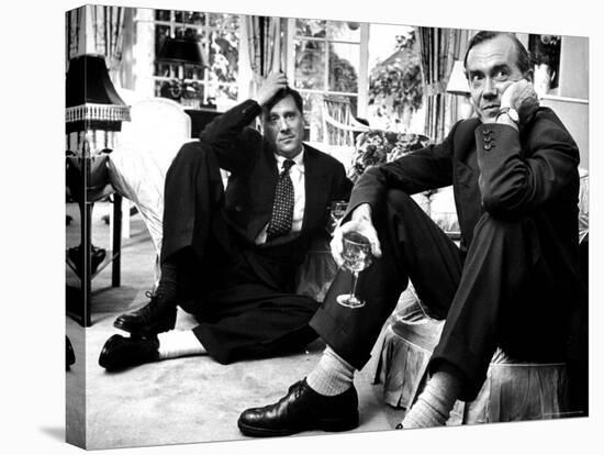 Film Director Carol Reed and Author Graham Greene Sitting on the Floor with Wine Glasses-Larry Burrows-Stretched Canvas