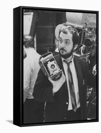 Film Director Stanley Kubrick Holding Polaroid Camera During Filming of "2001: A Space Odyssey"-Dmitri Kessel-Framed Stretched Canvas