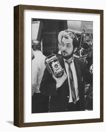 Film Director Stanley Kubrick Holding Polaroid Camera During Filming of "2001: A Space Odyssey"-Dmitri Kessel-Framed Premium Photographic Print