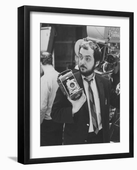 Film Director Stanley Kubrick Holding Polaroid Camera During Filming of "2001: A Space Odyssey"-Dmitri Kessel-Framed Premium Photographic Print