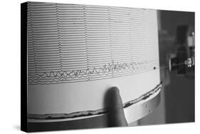 Finger Pointing to Earthquake Reading on Seismograph-null-Stretched Canvas