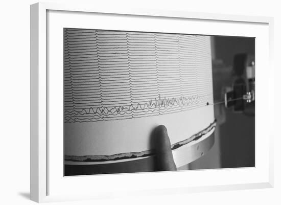 Finger Pointing to Earthquake Reading on Seismograph-null-Framed Photographic Print