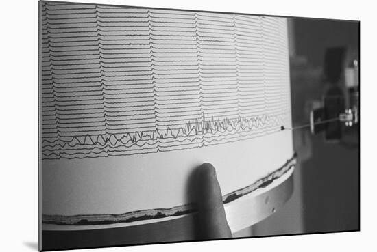 Finger Pointing to Earthquake Reading on Seismograph-null-Mounted Photographic Print