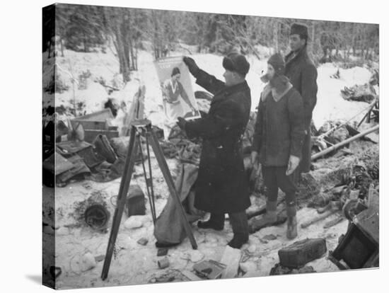 Finnish Soldiers Looking at a Patriotic Poster Left Behind by Defeated Russian Troops-Carl Mydans-Stretched Canvas