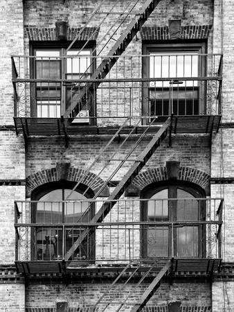 https://imgc.allpostersimages.com/img/posters/fire-escape-stairway-on-manhattan-building-new-york-united-states-black-and-white-photography_u-L-PZ2T8E0.jpg?artPerspective=n