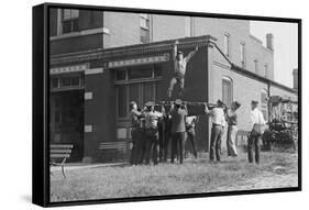 Firefighter Jumps Into Net Held By Fellow Firemen-null-Framed Stretched Canvas