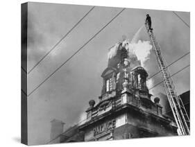 Fireman on Ladder Using a Hose to Extinguish Blazing Building Set Afire-Hans Wild-Stretched Canvas