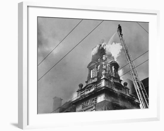 Fireman on Ladder Using a Hose to Extinguish Blazing Building Set Afire-Hans Wild-Framed Photographic Print
