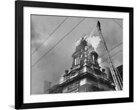 Fireman on Ladder Using a Hose to Extinguish Blazing Building Set Afire-Hans Wild-Framed Photographic Print