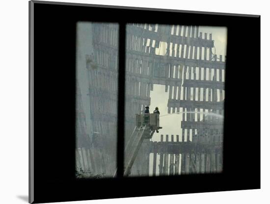 Firemen are Seen Spraying Water on the Smoldering Ruins of the World Trade Center-null-Mounted Photographic Print