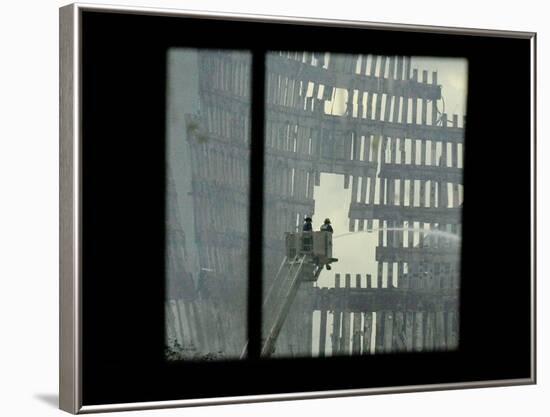 Firemen are Seen Spraying Water on the Smoldering Ruins of the World Trade Center-null-Framed Photographic Print