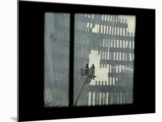 Firemen are Seen Spraying Water on the Smoldering Ruins of the World Trade Center-null-Mounted Photographic Print