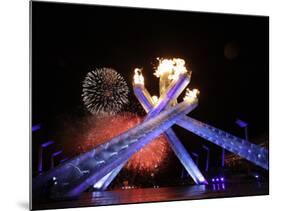 Fireworks Explode Behind the Olympic Flame at Opening Ceremony of Vancouver 2010 Winter Games-null-Mounted Photographic Print