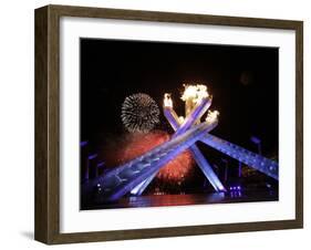 Fireworks Explode Behind the Olympic Flame at Opening Ceremony of Vancouver 2010 Winter Games-null-Framed Photographic Print