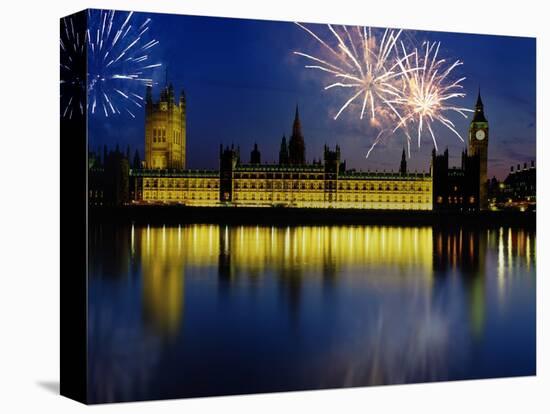 Fireworks exploding over the Houses of Parliament and the river Thames, London, England-null-Stretched Canvas