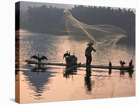 Fisherman Fishing with Cormorants on Bamboo Raft on Li River at Dusk, Yangshuo, Guangxi, China-Keren Su-Stretched Canvas