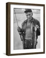 Fisherman Lauri Rapala, Who Handmakes Fishing Lures, with a Fish He Caught-null-Framed Photographic Print