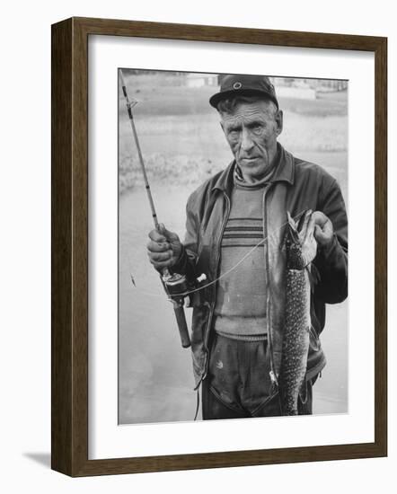 Fisherman Lauri Rapala, Who Handmakes Fishing Lures, with a Fish He Caught-null-Framed Photographic Print