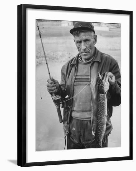 Fisherman Lauri Rapala, Who Handmakes Fishing Lures, with a Fish He Caught-null-Framed Photographic Print