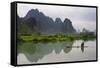 Fisherman on bamboo raft on Mingshi River at sunset, Mingshi, Guangxi Province, China-Keren Su-Framed Stretched Canvas