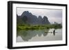 Fisherman on bamboo raft on Mingshi River at sunset, Mingshi, Guangxi Province, China-Keren Su-Framed Photographic Print