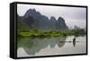 Fisherman on bamboo raft on Mingshi River at sunset, Mingshi, Guangxi Province, China-Keren Su-Framed Stretched Canvas