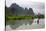 Fisherman on bamboo raft on Mingshi River at sunset, Mingshi, Guangxi Province, China-Keren Su-Stretched Canvas