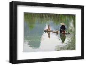 Fisherman on bamboo raft on Mingshi River with karst hills, Mingshi, Guangxi Province, China-Keren Su-Framed Photographic Print